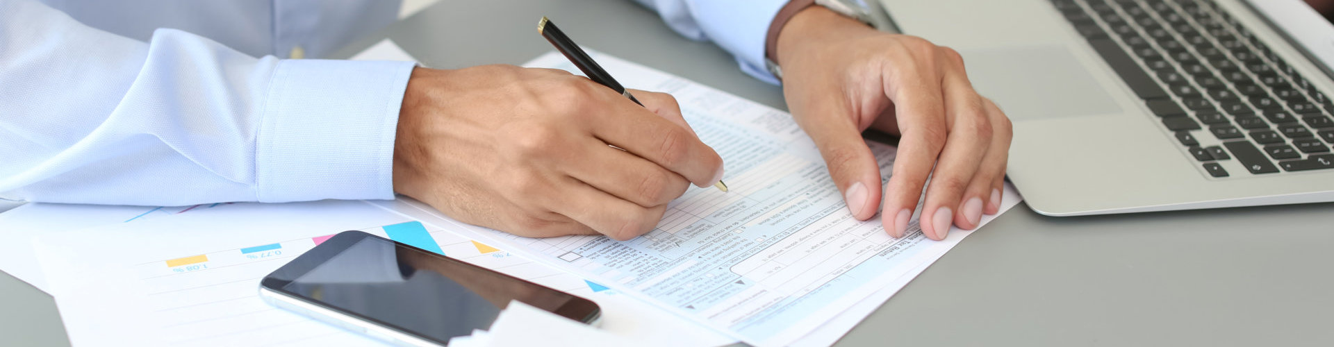 accountant working with documents at table