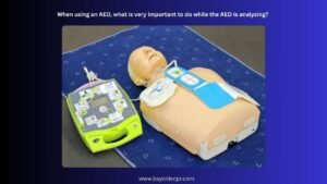 When using an AED, what is very important to do while the AED is analyzing?